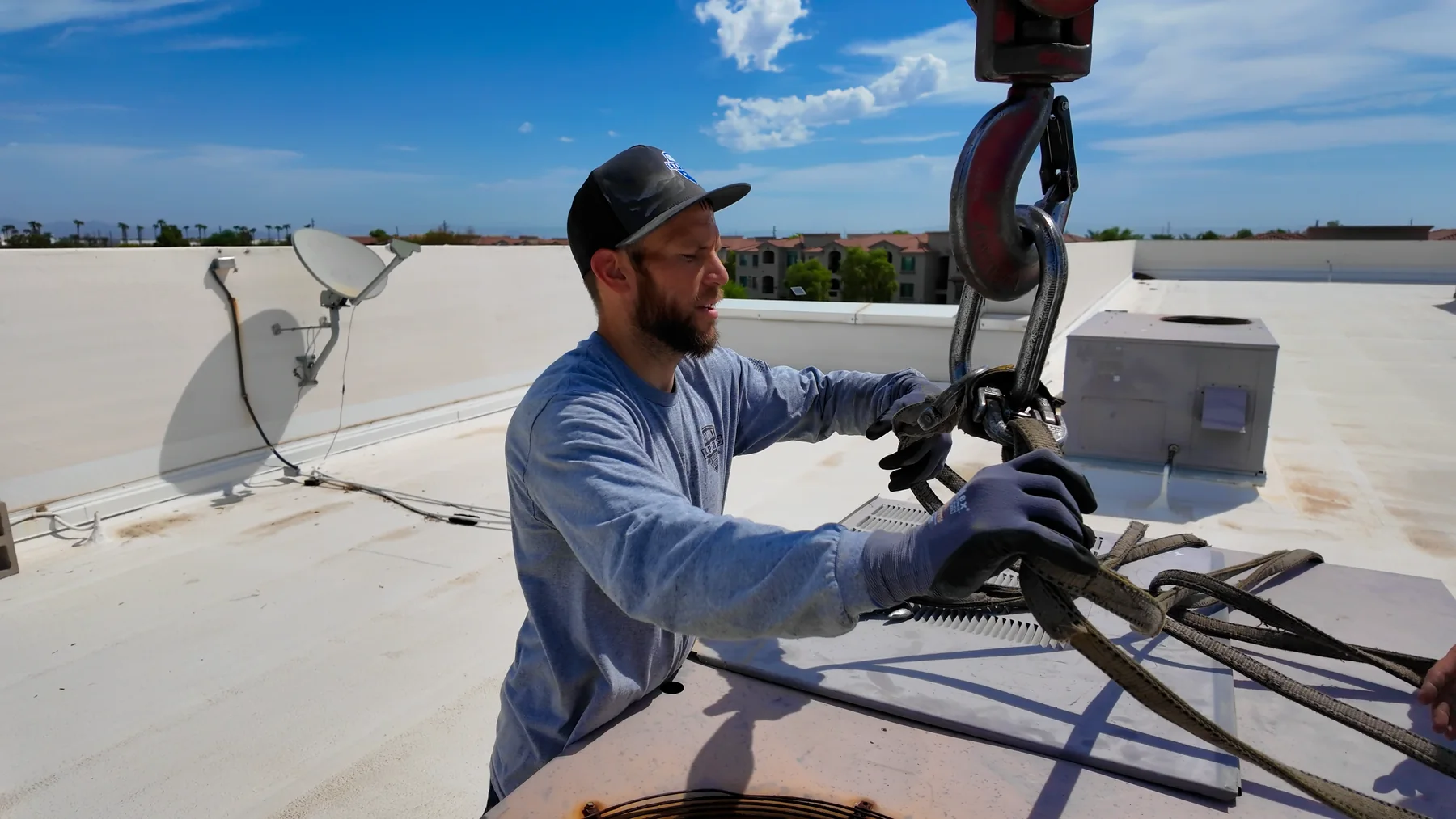 Comfort Experts technician handling rooftop HVAC rigging